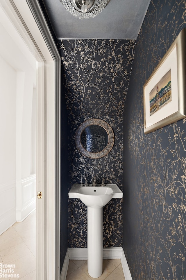 bathroom featuring wallpapered walls, baseboards, and tile patterned flooring