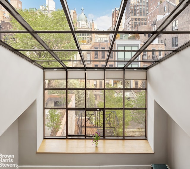 stairs featuring a city view, a towering ceiling, and a wealth of natural light