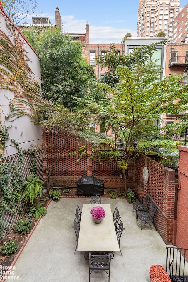 view of patio with grilling area and fence