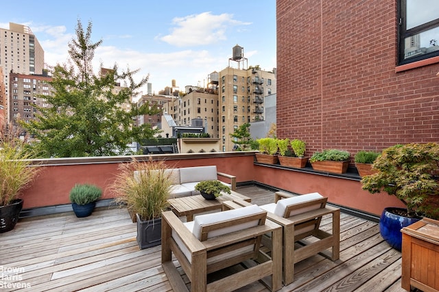 deck with outdoor lounge area and a view of city