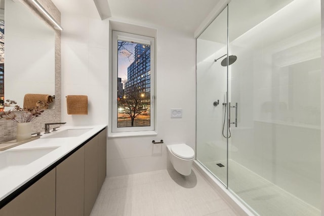 bathroom with tile walls, vanity, toilet, tile patterned floors, and a shower with door