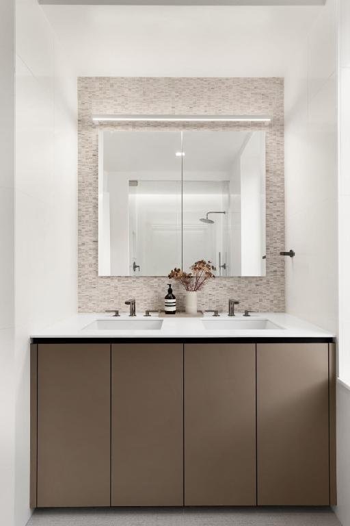 bathroom with decorative backsplash and vanity