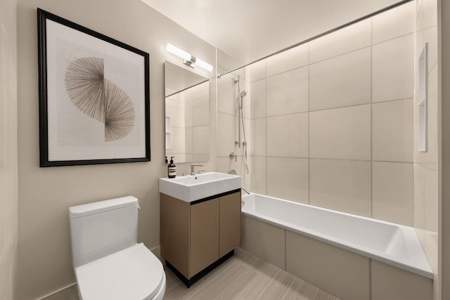 full bathroom featuring toilet, vanity, and tiled shower / bath combo