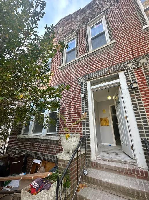 view of front of house featuring entry steps and brick siding