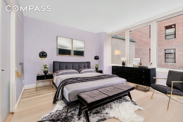 bedroom with baseboards and light wood-type flooring
