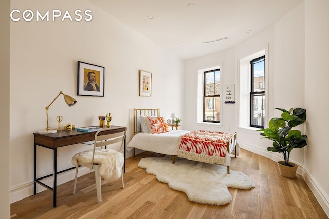 bedroom featuring light wood-style floors and baseboards