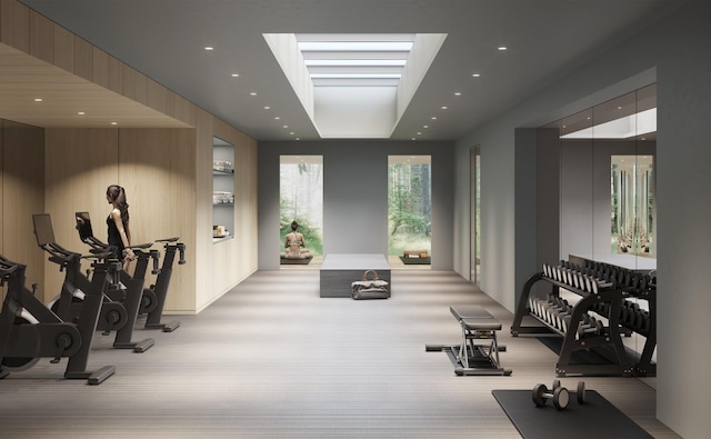 exercise room with recessed lighting and a raised ceiling