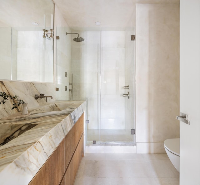 full bath with a stall shower, tile patterned flooring, vanity, and toilet