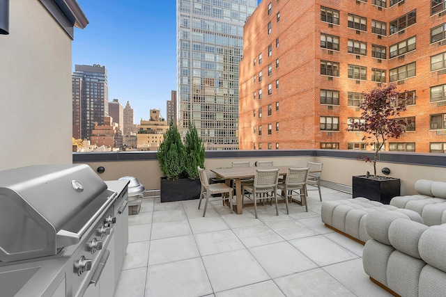 view of patio with outdoor dining area, area for grilling, and a city view