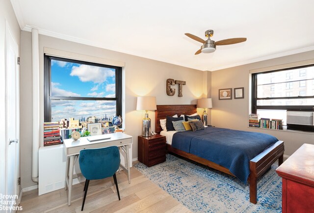 bedroom featuring light wood-type flooring, ceiling fan, and ornamental molding