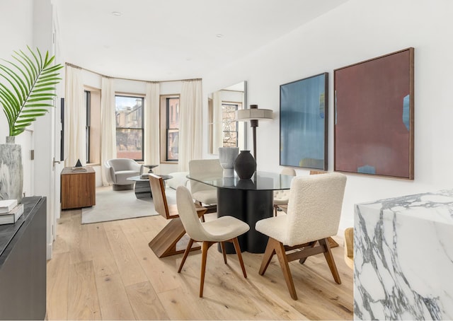 dining area with light wood-style flooring