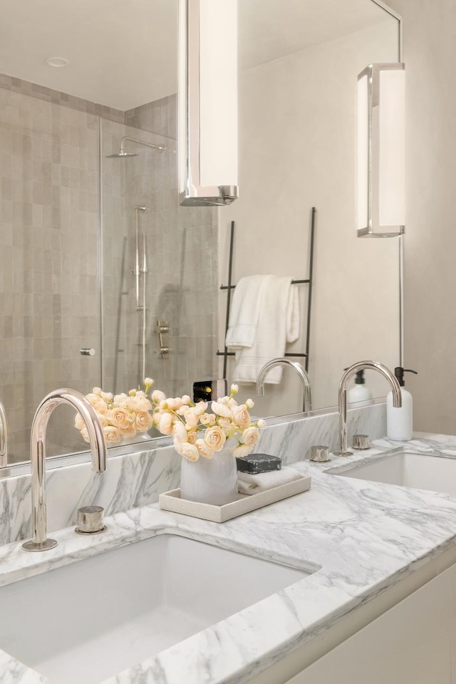 interior details featuring vanity and a stall shower