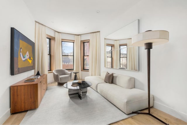 living room featuring light wood finished floors and baseboards