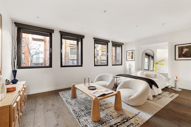 bedroom with baseboards and dark wood finished floors