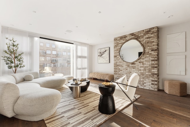 living area with a wall of windows and wood finished floors