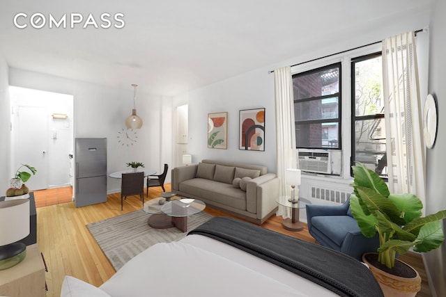 60 E 9th St Unit 235, New York City, NY 10003 - living room featuring light wood-type flooring and cooling unit