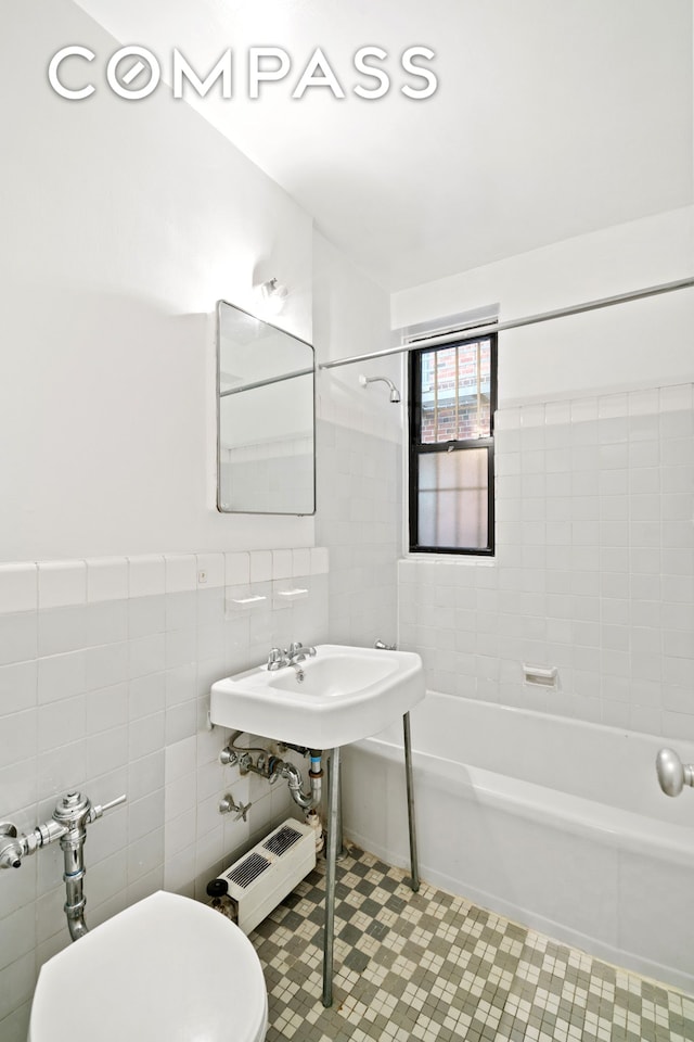 60 E 9th St Unit 235, New York City, NY 10003 - full bath with tile walls, shower / tub combination, toilet, and tile patterned flooring