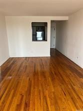 unfurnished room with dark hardwood / wood-style flooring