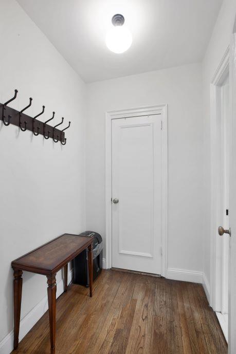 living room with dark hardwood / wood-style flooring and crown molding