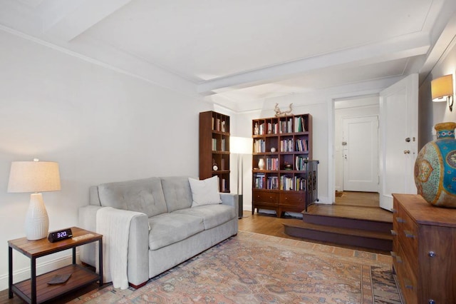 living room with beamed ceiling and wood finished floors