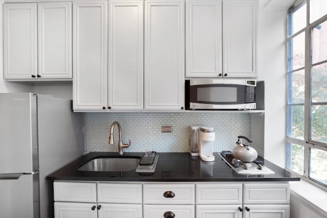 10 Park Ave Unit 2-C, New York City, NY 10016 - kitchen with appliances with stainless steel finishes, a sink, white cabinetry, and backsplash