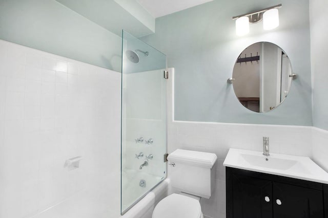 10 Park Ave Unit 2-C, New York City, NY 10016 - full bathroom featuring toilet, vanity, shower / washtub combination, wainscoting, and tile walls