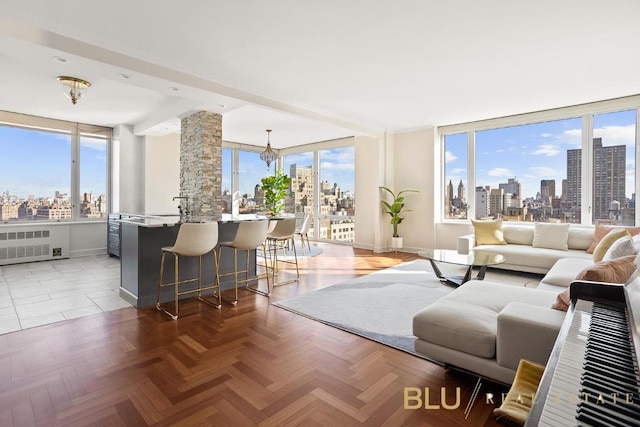 living room with parquet floors and a notable chandelier