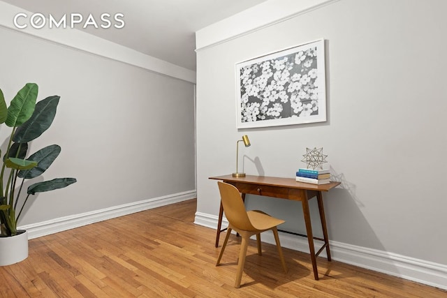 office area with wood finished floors and baseboards