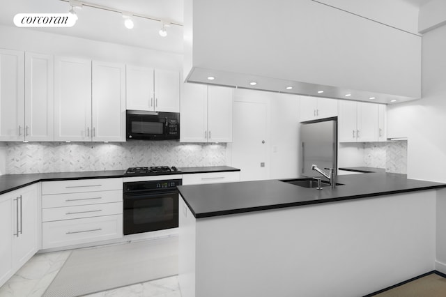 kitchen with black appliances, dark countertops, marble finish floor, and a sink