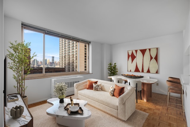 living room featuring radiator, parquet floors, and plenty of natural light