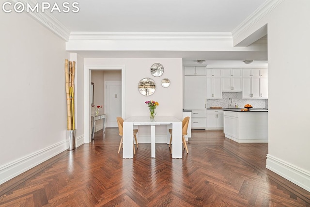 unfurnished dining area with dark parquet floors, sink, and crown molding