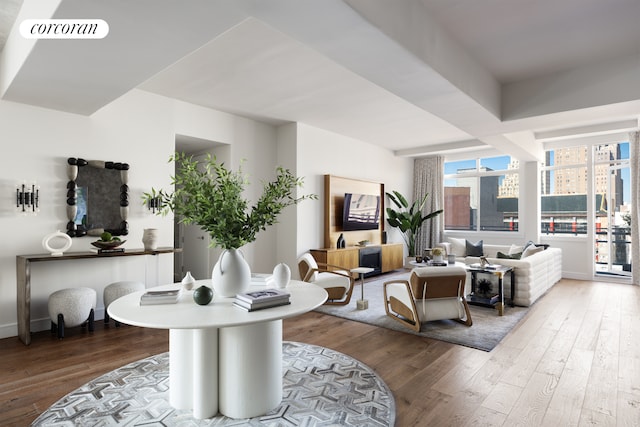 living room featuring baseboards, visible vents, and wood finished floors