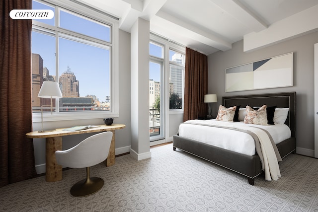 bedroom with a view of city, baseboards, and beamed ceiling