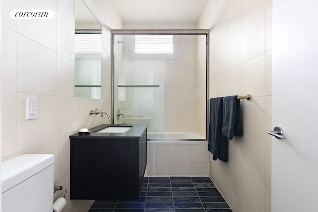 123 Baxter St Unit Ph7B, New York City, NY 10013 - bathroom featuring vanity, tile patterned flooring, toilet, tiled shower / bath combo, and tile walls