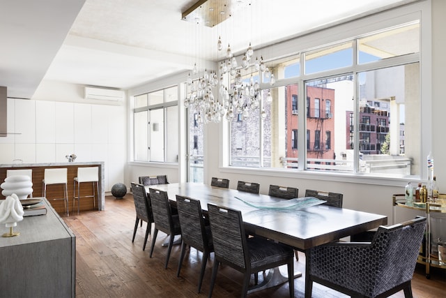 dining space featuring a wall mounted AC and wood-type flooring