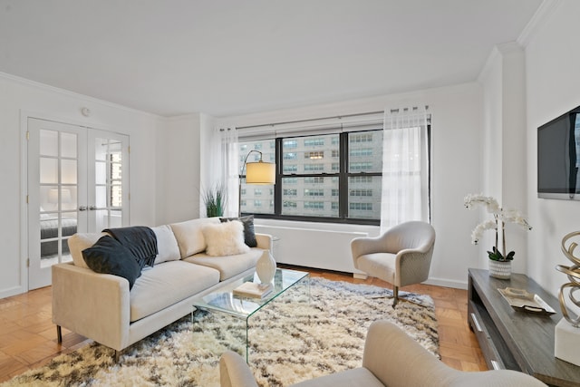 living area with ornamental molding, french doors, a healthy amount of sunlight, and baseboards