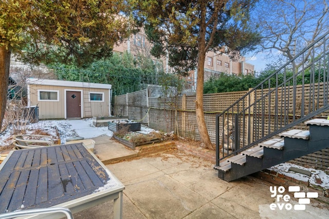 view of patio / terrace with stairway, an outdoor structure, and fence