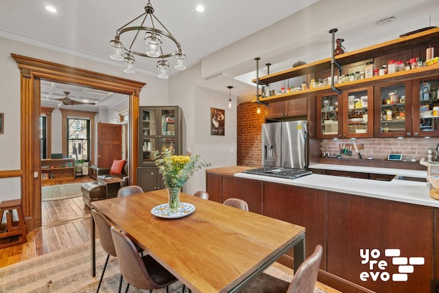 dining room with recessed lighting, light wood-style flooring, and ornamental molding