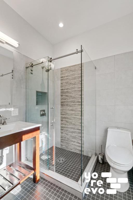 full bathroom with tile patterned flooring, a shower stall, toilet, and tile walls