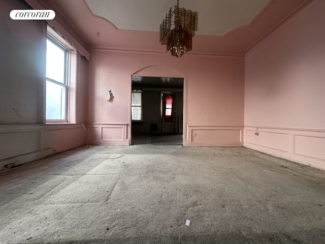 spare room with a notable chandelier