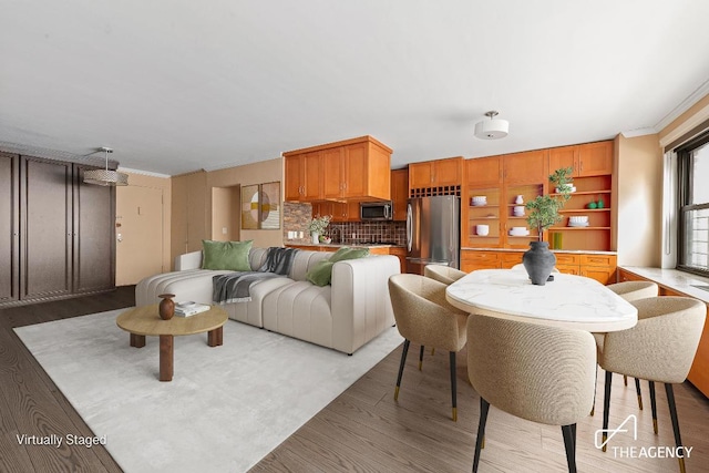 interior space with hardwood / wood-style floors and crown molding