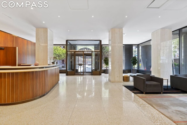 reception area with a jacuzzi and decorative columns