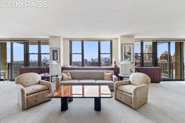 living room with light colored carpet, floor to ceiling windows, and a textured ceiling