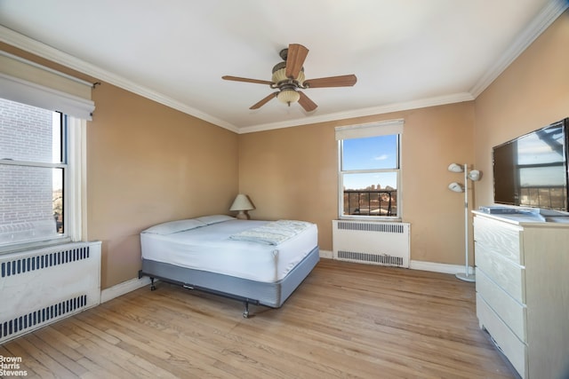 bedroom featuring radiator, light wood-style flooring, and ornamental molding