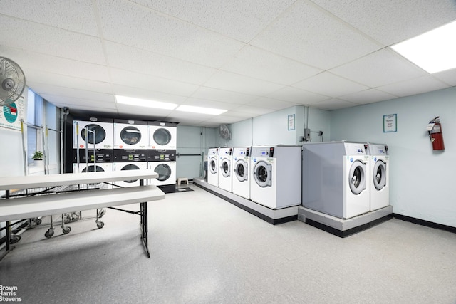 community laundry room with baseboards, separate washer and dryer, stacked washer / dryer, and tile patterned floors