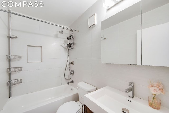 full bathroom featuring toilet, tile walls, decorative backsplash, vanity, and tiled shower / bath