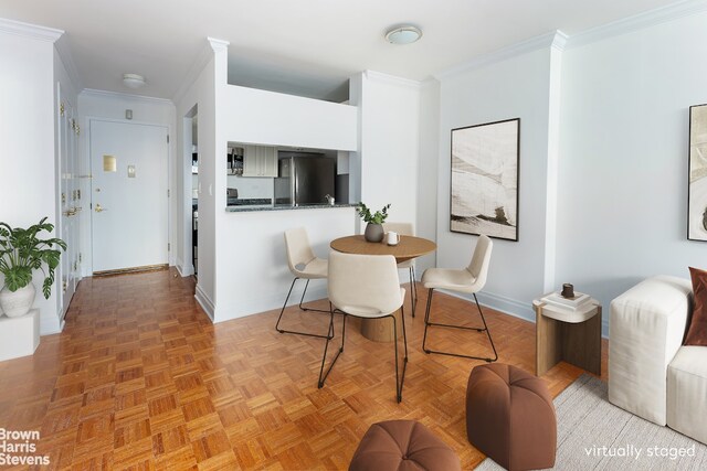 dining area with ornamental molding and light parquet flooring