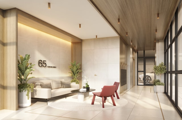 living room featuring sink, light hardwood / wood-style floors, and floor to ceiling windows