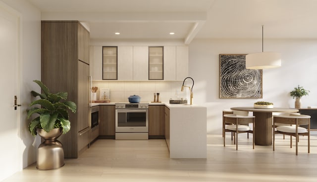 kitchen with tasteful backsplash, hanging light fixtures, light wood-type flooring, stainless steel electric range, and white cabinets