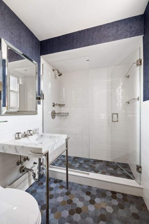 bathroom featuring a shower with shower door